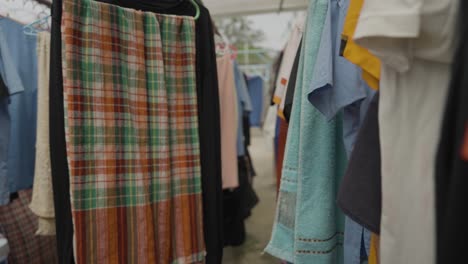 textiles usage and quality, second hand clothes hanging for drying in poor area neighborhood, depiction of everyday life