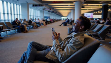 man using mobile phone at airport