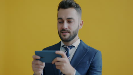 businessman playing mobile game