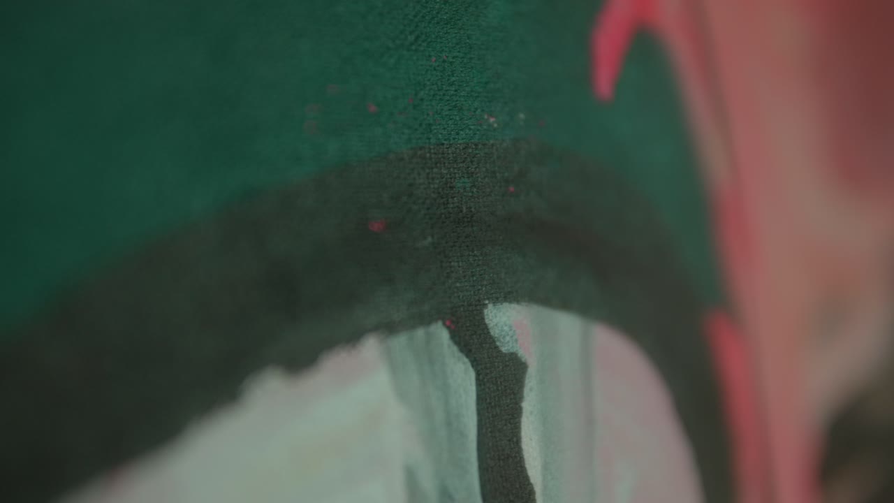 Woman walks down a dimly lit street at night holding a drink