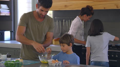 family in kitchen making morning breakfast together