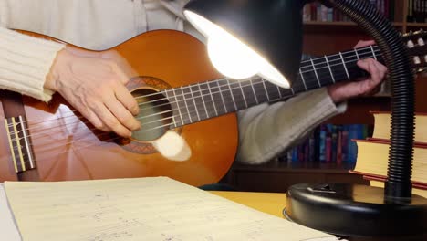 close up of female hands playing guitar. woman studying to play guitar. hobby and leisure activities