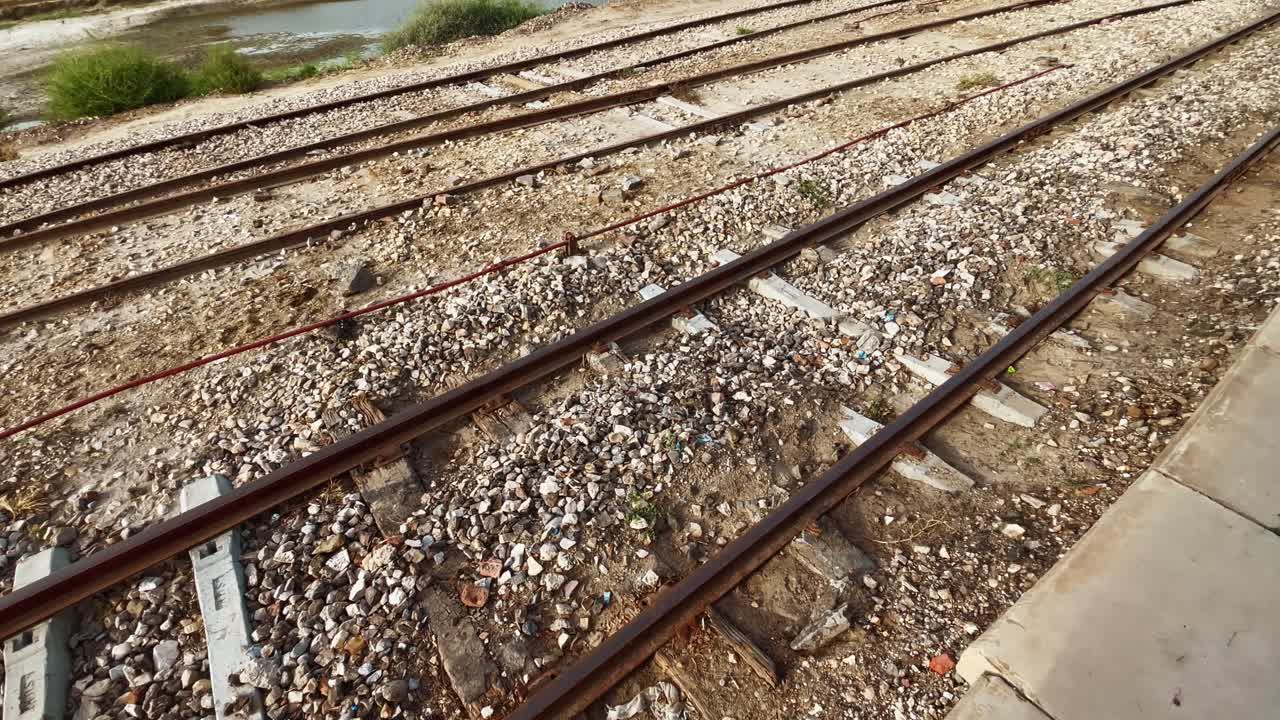 Rusty railway tracks converging at Ghotki Railway Station, showcasing the transportation infrastructure in Sindh, Pakistan
