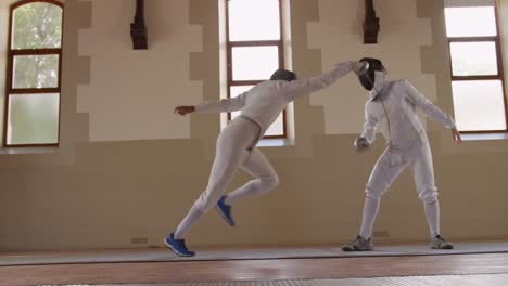 fencer athletes during a fencing training in a gym