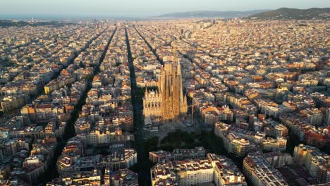 aerial view of barcelona eixample residential district and famous basilica sagrada familia at sunrise. catalonia, spain