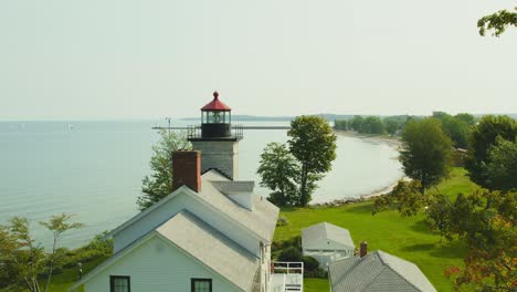 Drone-shot-rising-of-the-Big-light-house-museum-at-Sodus-point-New-York-vacation-spot-at-the-tip-of-land-on-the-banks-of-Lake-Ontario
