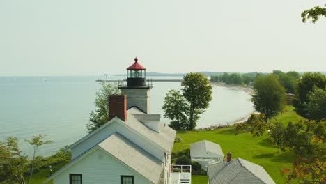 drone shot rising of the big light house museum at sodus point new york vacation spot at the tip of land on the banks of lake ontario