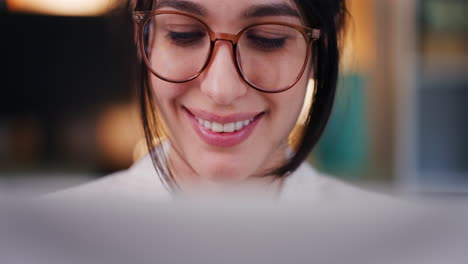 Happy-Woman-with-Glasses-Working-on-Laptop-at-Night