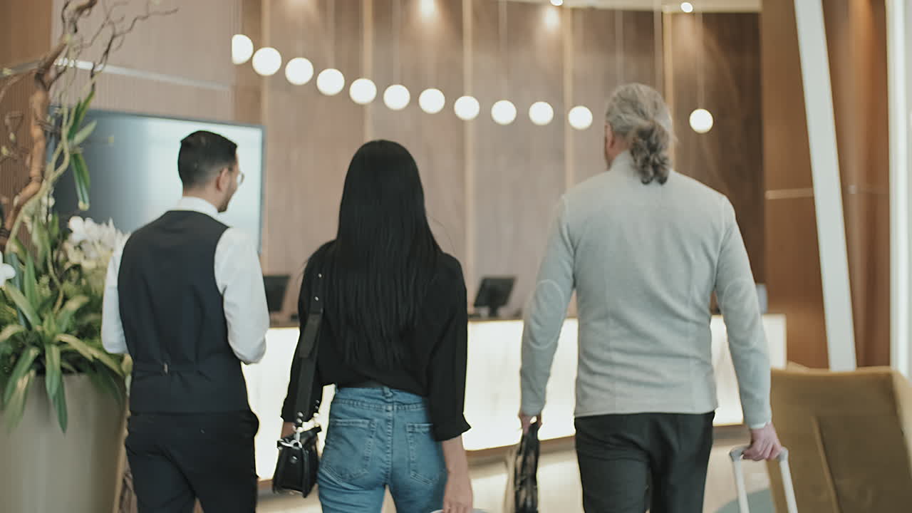 Concierge Escorting Guests to Reception Desk