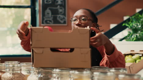 vendor placing crates of fruits and veggies on shelves