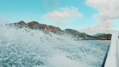 Cinematic-closeup-of-the-water-being-splashed-by-a-jet-ski-while-riding-through-the-blue-ocean-in-the-Philippines-in-Asia,-Slomo,-Slow-Motion,-Waverunner