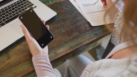 Caucasian-pregnant-woman-working-remotely-using-laptop-and-smartphone-with-copy-space