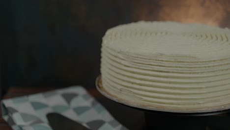 close-up of a delicious frosted cake rotating on a stand