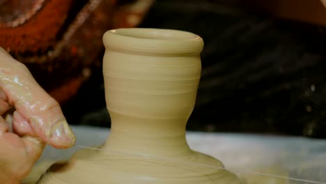 professional male potter working in workshop, studio