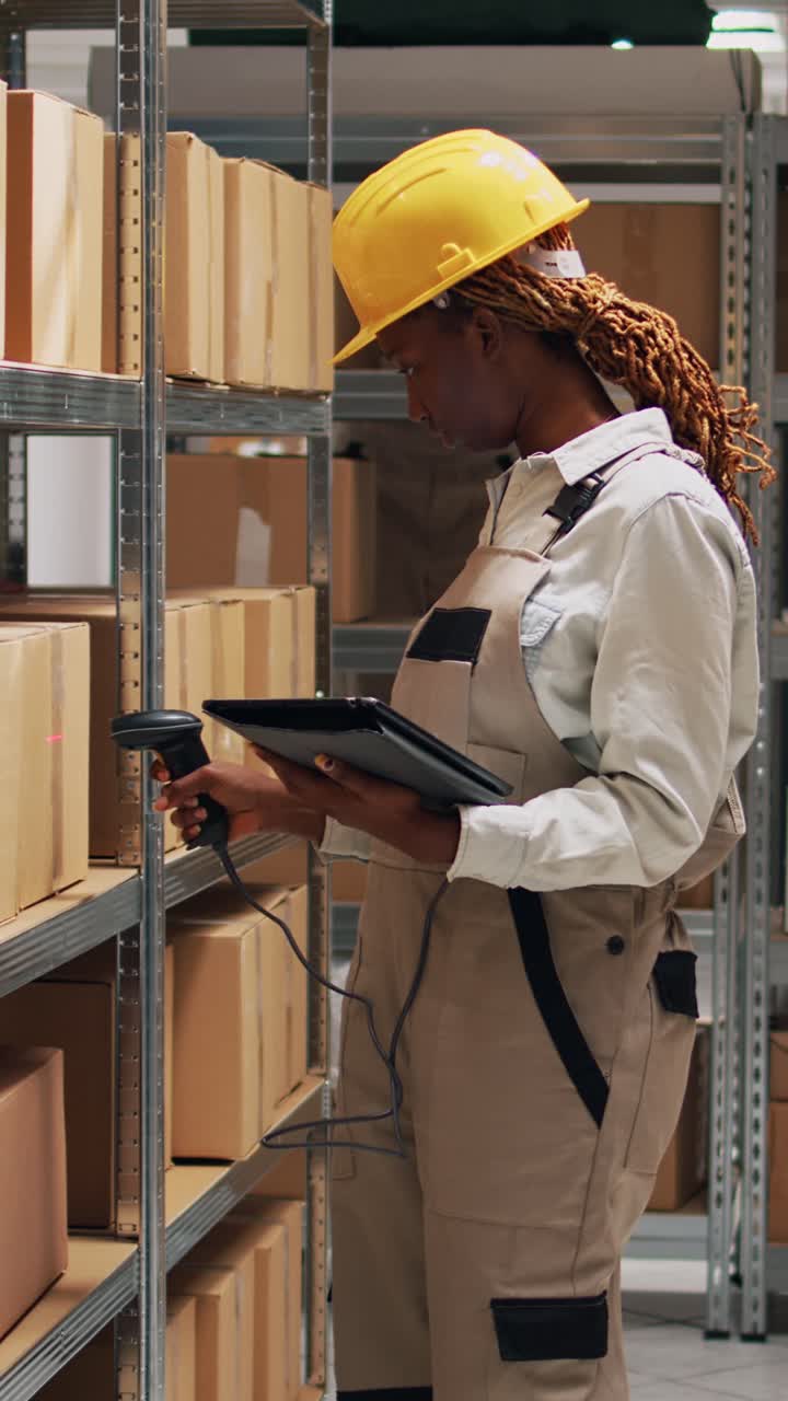 Vertical video: African american woman holding tablet to scan barcodes
