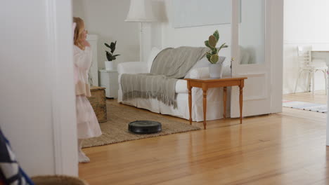happy-little-girl-dancing-playfully-with-robot-vacuum-cleaner-funny-child-pretending-to-be-ballerina-having-fun-playing-dress-up-wearing-fairy-wings-ballet-costume-at-home-4k