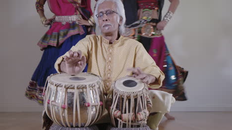 indian percussion musician with dancers 02