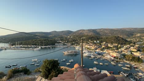 looking over a root at the sivota pier and port in the summer evening, time lapse