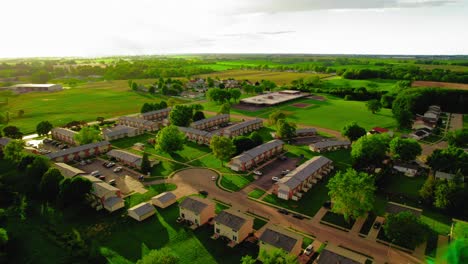 Aerial-view-of-Davenport,-Iowa,-showing-residential-complexes,-green-spaces,-and-surrounding-countryside-on-a-sunny-day