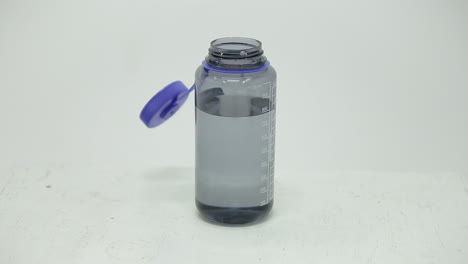 dropping a dry ice cube into a water bottle