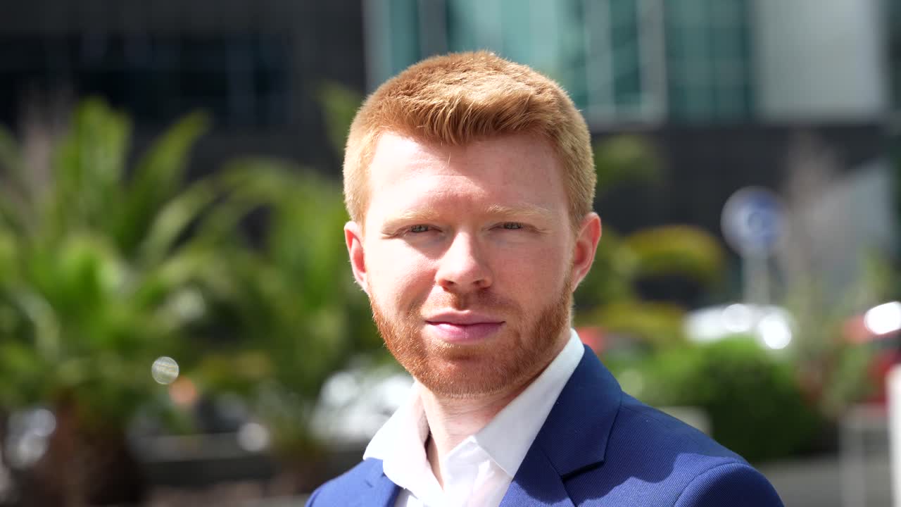Portrait of a red-haired businessman outdoors