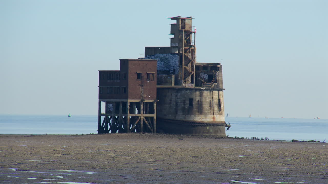 Pan Up to Reveal an Abandoned Sea Fort on Coastal Mudflats