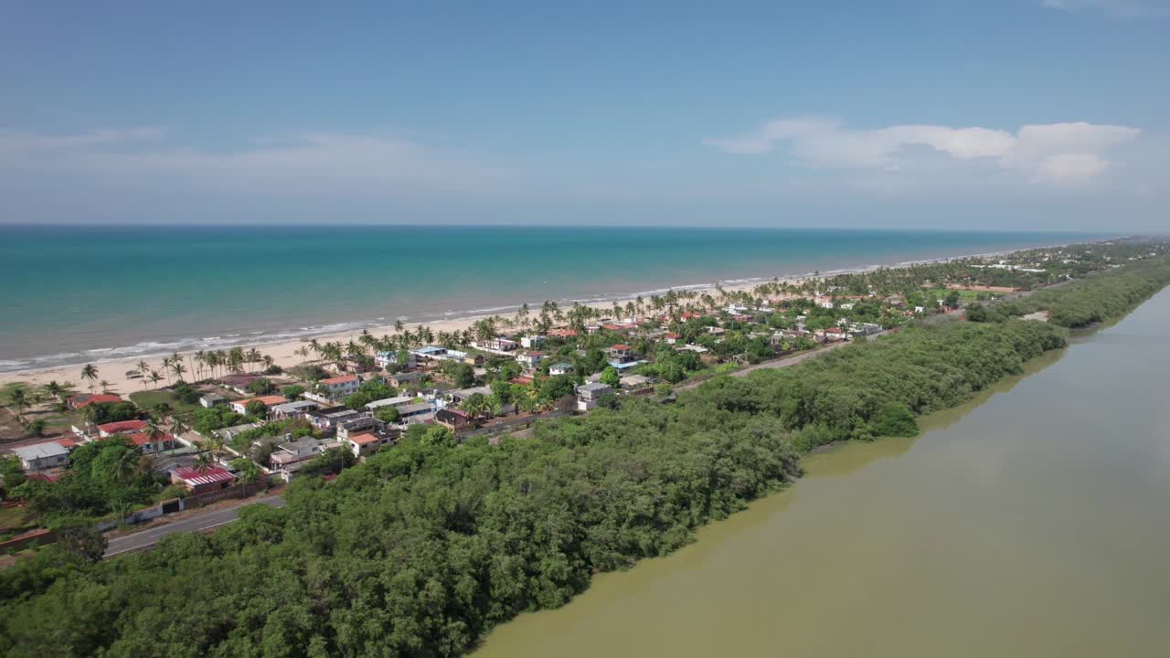 Unforgettable cinematic view of the iconic Venezuelan highway, a narrow ribbon of asphalt running between the deep blue Caribbean and the vast, earthy Unare Lagoon