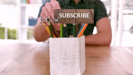 Animation-of-subscribe-and-follow-over-hands-of-diverse-coworkers-taking-pencils-from-box