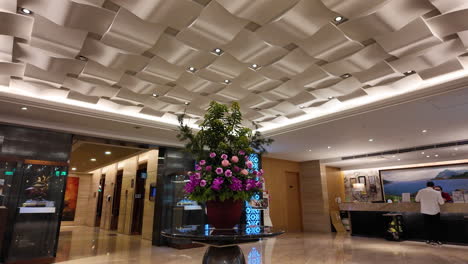 tilt shot of worker working at reserving desk inside hotel lobby in taipei taiwan