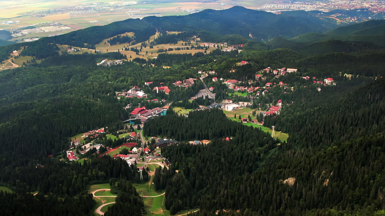Aerial drone view of Poiana Brasov, Romania. Town located in lush forest