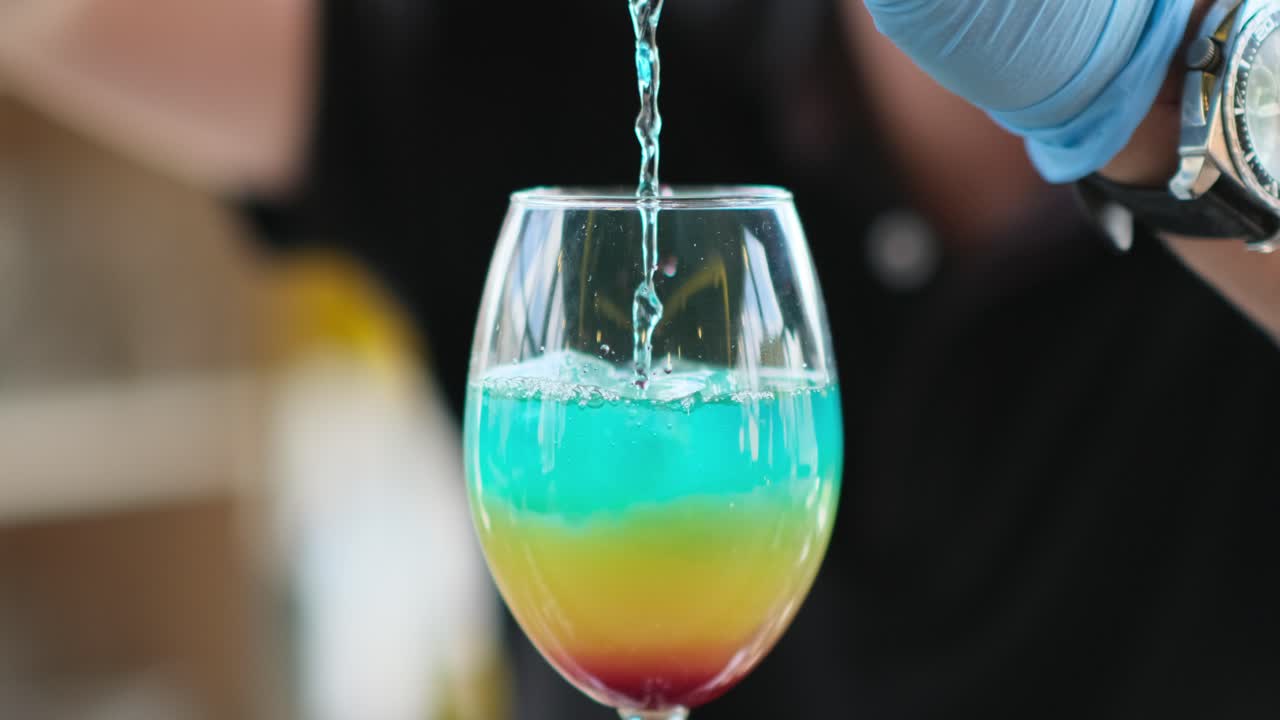 bartender prepares a cocktail in a glass