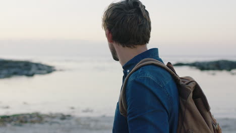 portrait of caucasian man on beach using phone taking photo of beautiful seaside ocean