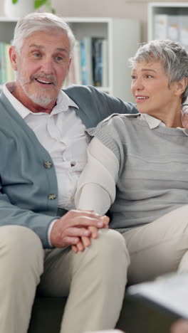 happy senior couple sitting on a couch