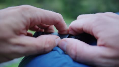 a sleeping back gets tightened with a buckle