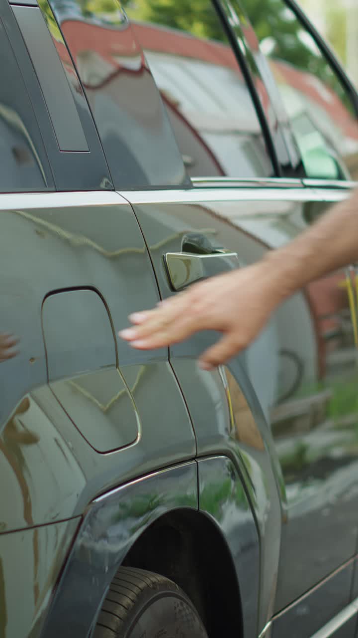 Vertical video Close up of man closing vehicle inlet of EV eco friendly SUV car after charging