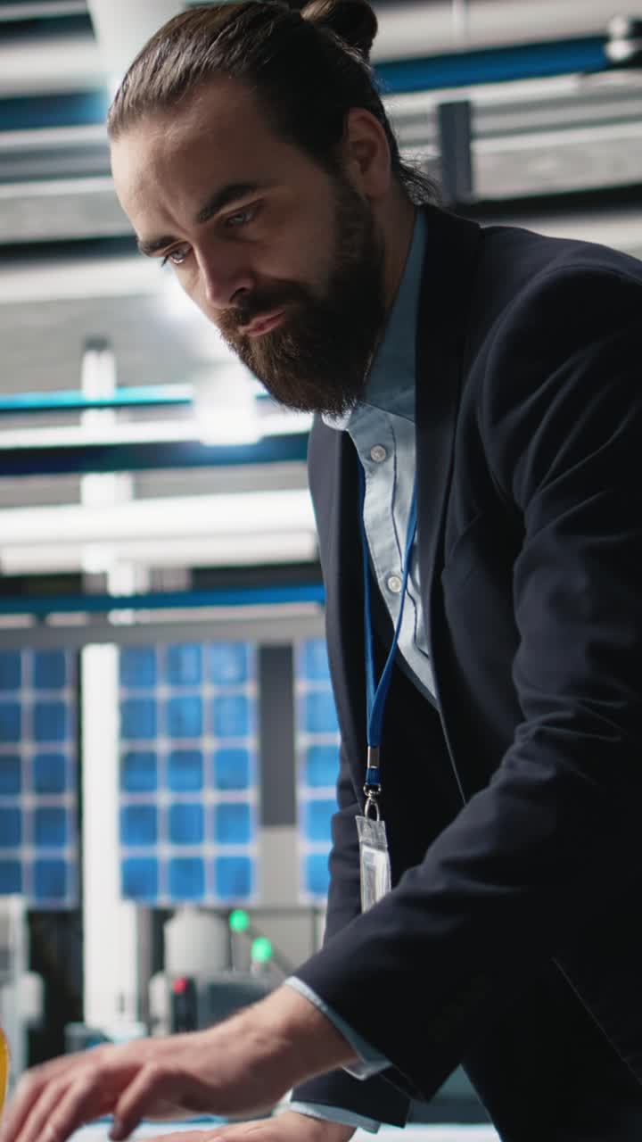 Vertical Video Supervisor analyst assesses solar panels production line in factory