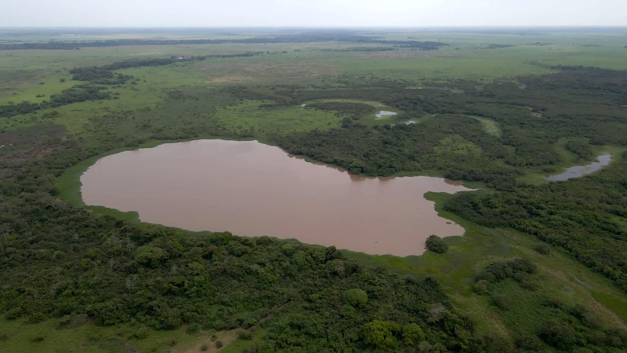 Aerial drone pullback over the winding Rio Yacuma, surrounded by Bolivia rich wetlands