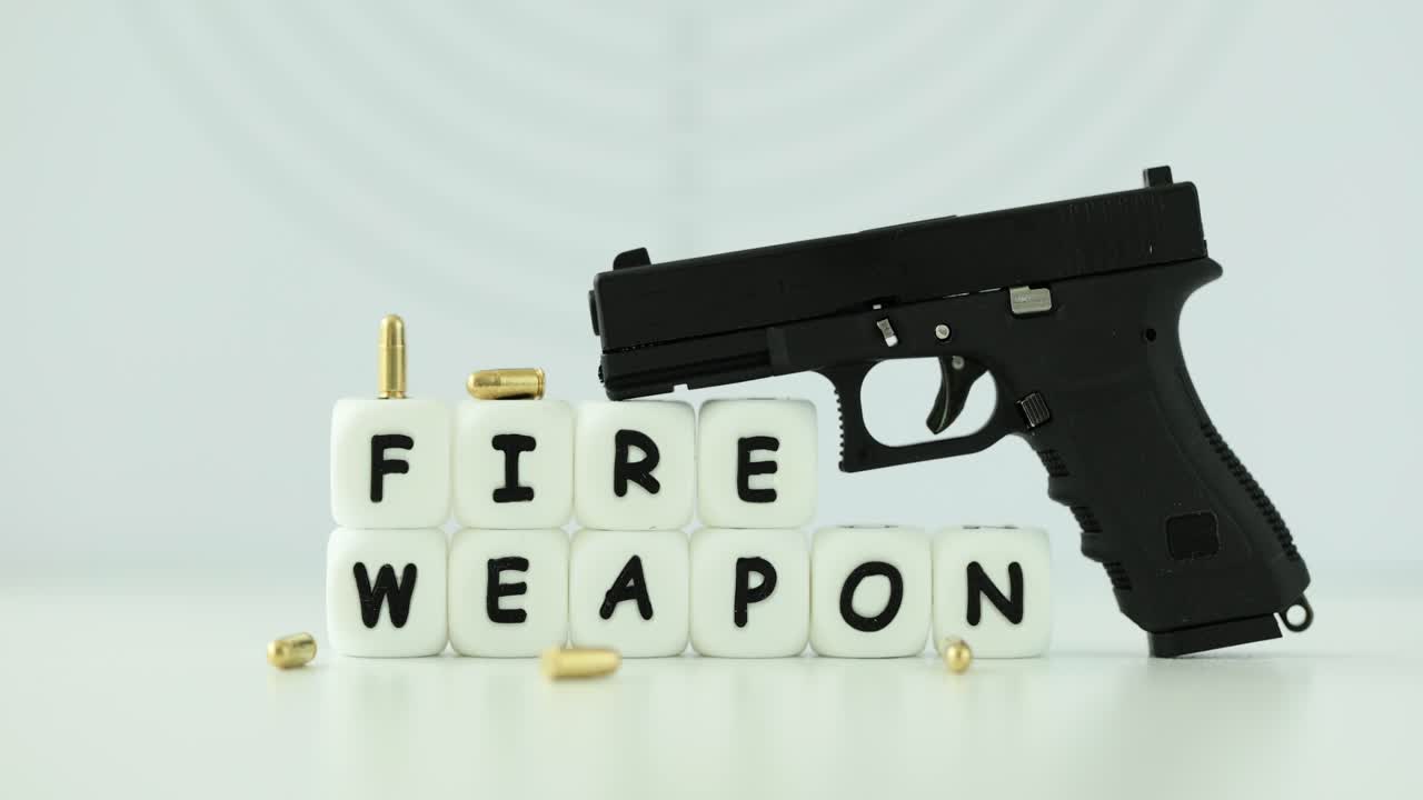 Black pistol with bullets and dice spelling 'FIRE WEAPON'