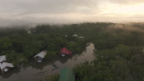 Boat-cruising-on-dulce-river-near-Rio-dulce-Guatemala,-aerial