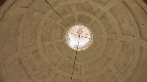 ornate church dome with an oculus casting soft light