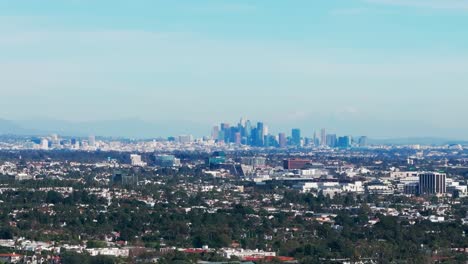 drone aerial shot of the los angeles skyline in california on sunny day