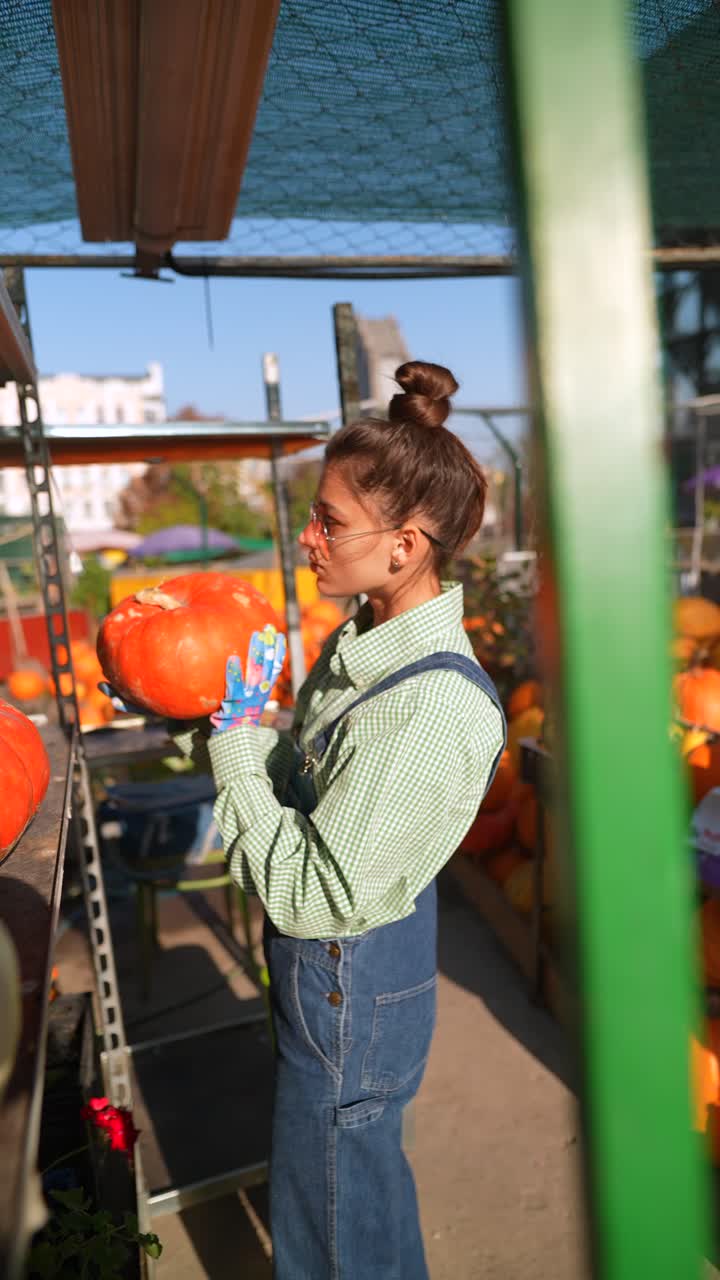 mujer recogiendo una calabaza en un mercado de agricultores