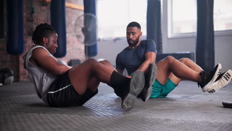 men doing medicine ball crunches in a gym