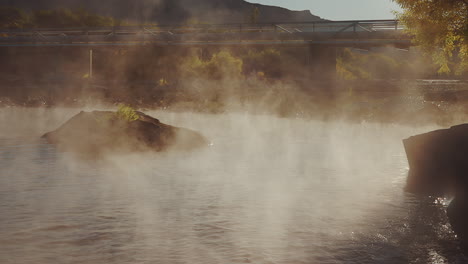 Calm-River-On-A-Misty-Morning-With-Steel-Bridge-In-The-Background