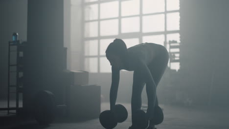 Sportswoman-exercising-with-heavy-dumbbells.-Woman-doing-squats-with-lunges