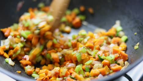 cooking and stirring vegetables in pan