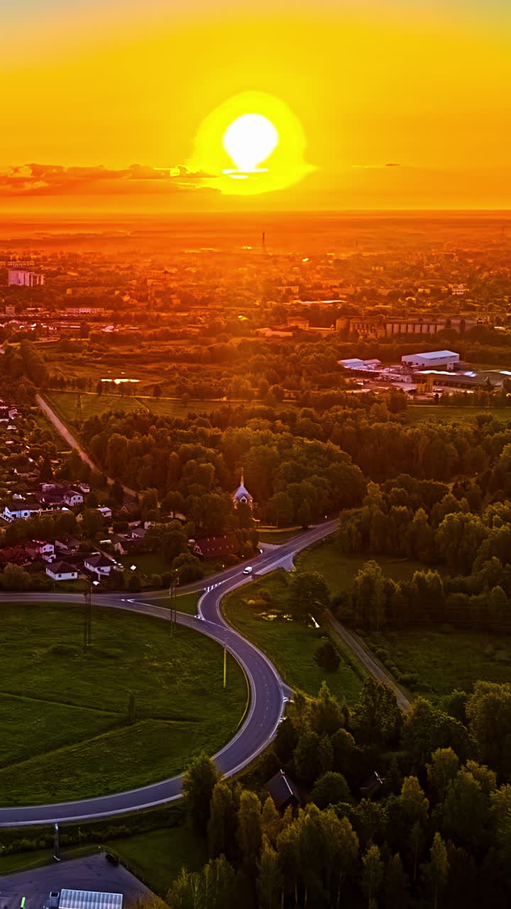 Stunning sunset timelapse over vibrant green landscape and winding road