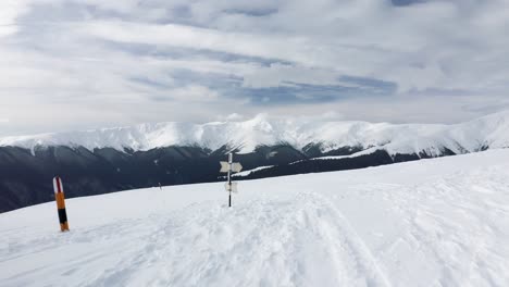 Snow-covered-peaks-of-Iezerul-Mare-and-Batrana-in-Iezer-Papusa-Mountains,-expansive-view,-daytime