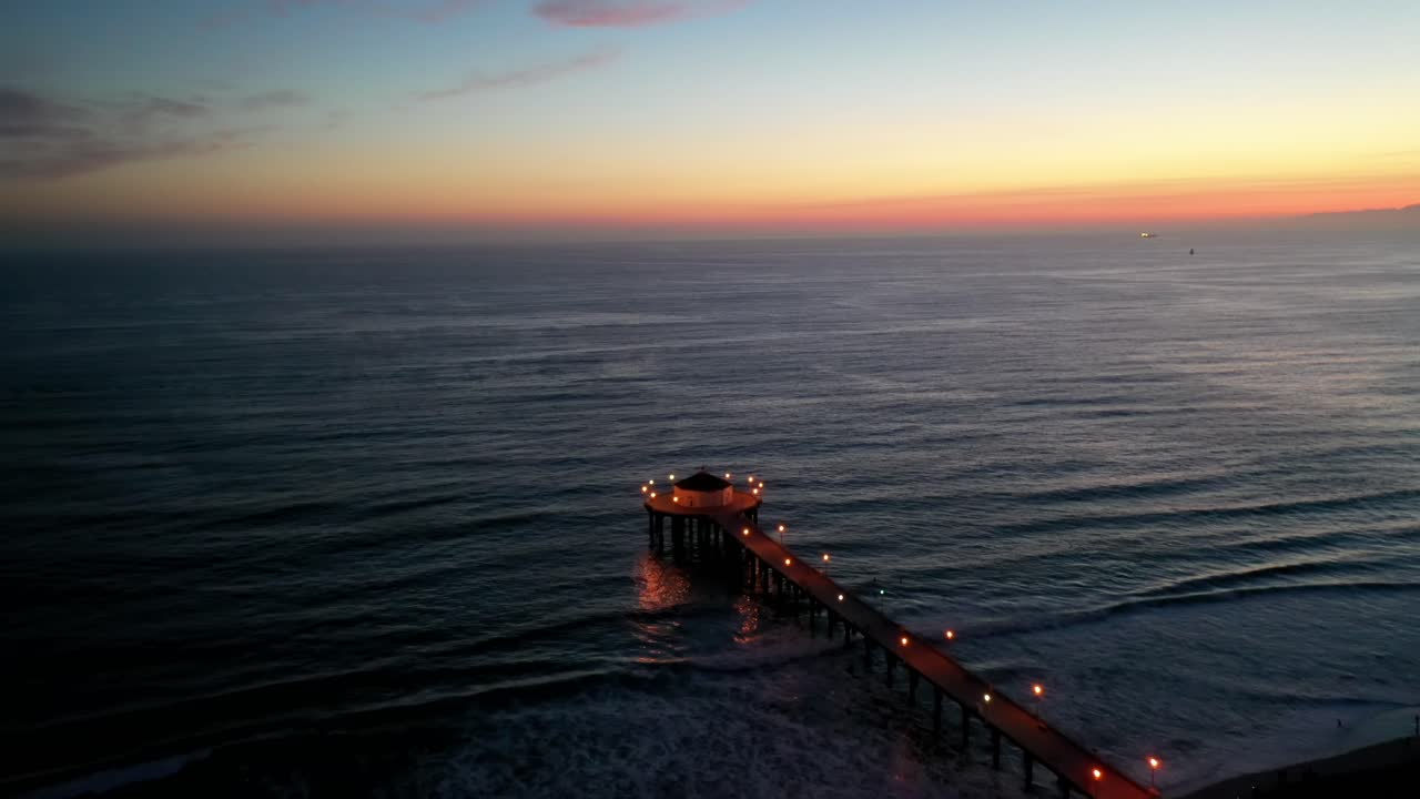Dramatic Lighted Pathway To A Gazebo In Manhattan Beach On A Sunset - aerial shot