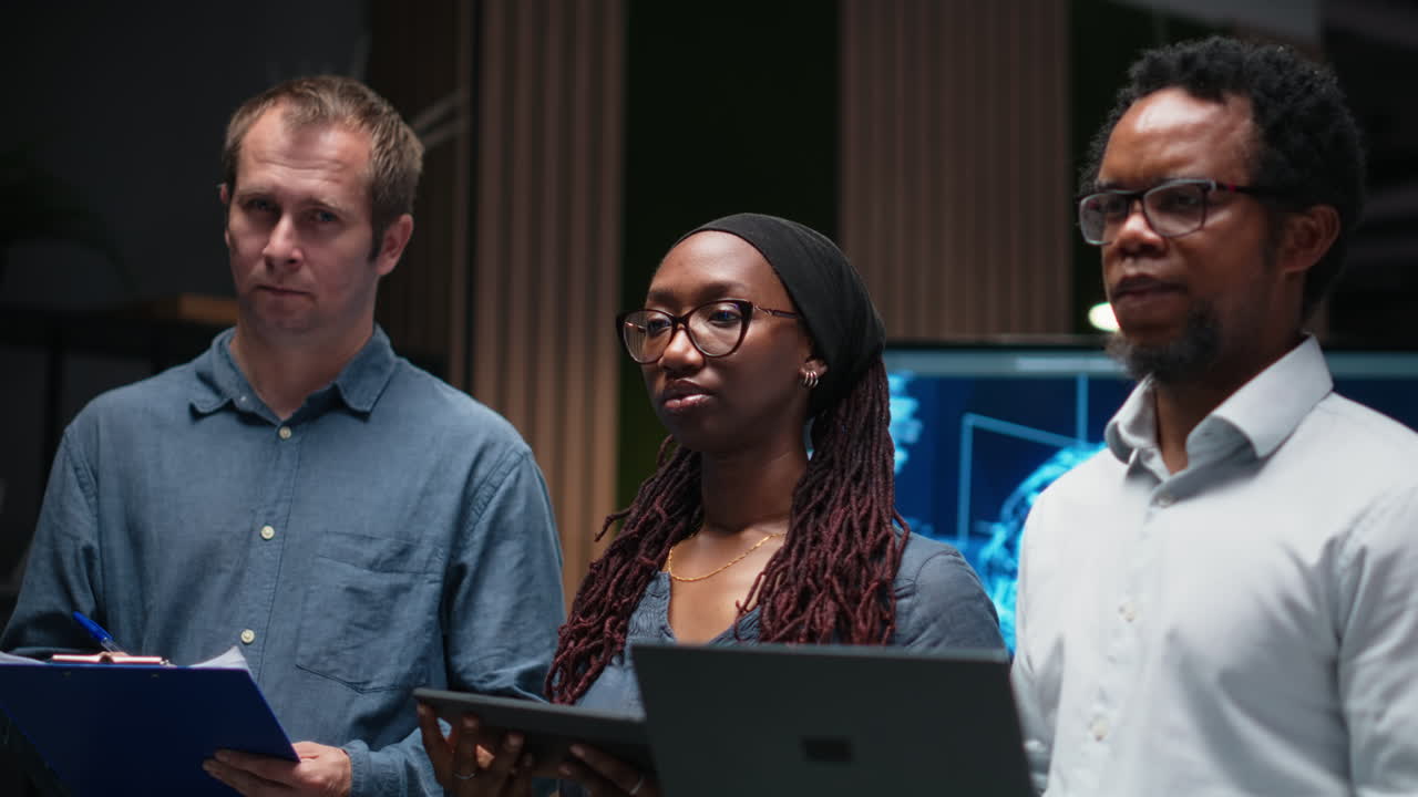 Diverse Business Team Standing Attentively in Modern Office Meeting